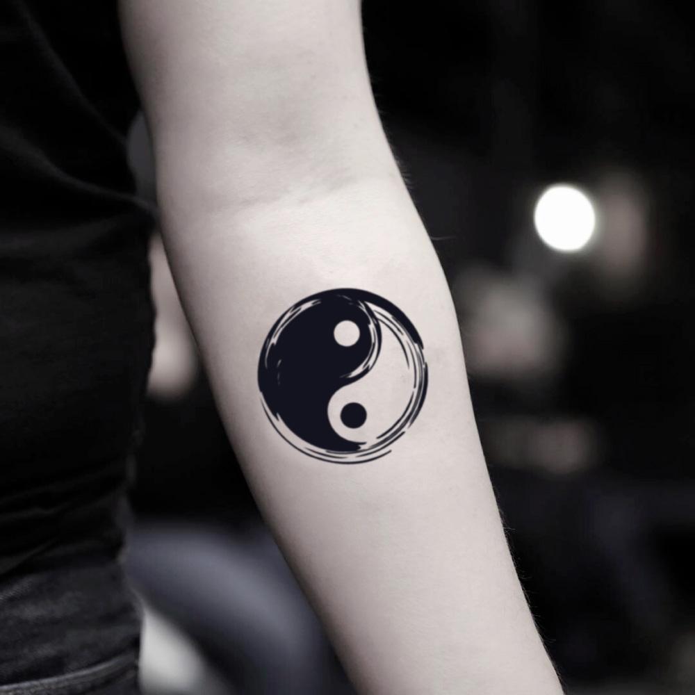 fake small bold yin yang symbol illustrative temporary tattoo sticker design idea on inner arm