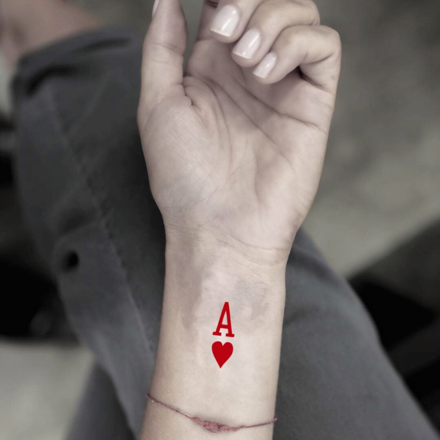 fake tiny ace of hearts color minimalist temporary tattoo sticker design idea on wrist