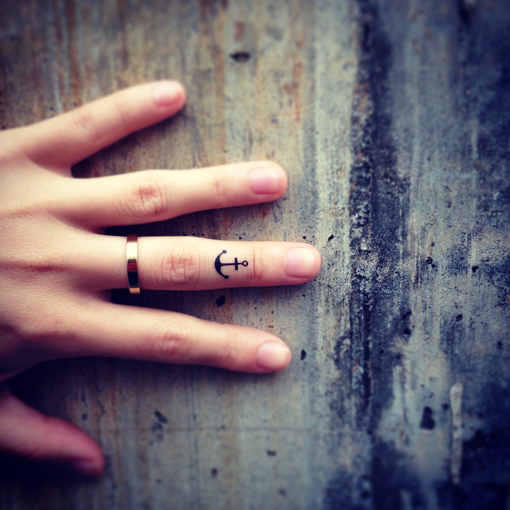 fake tiny little thin anchor minimalist temporary tattoo sticker design idea on finger