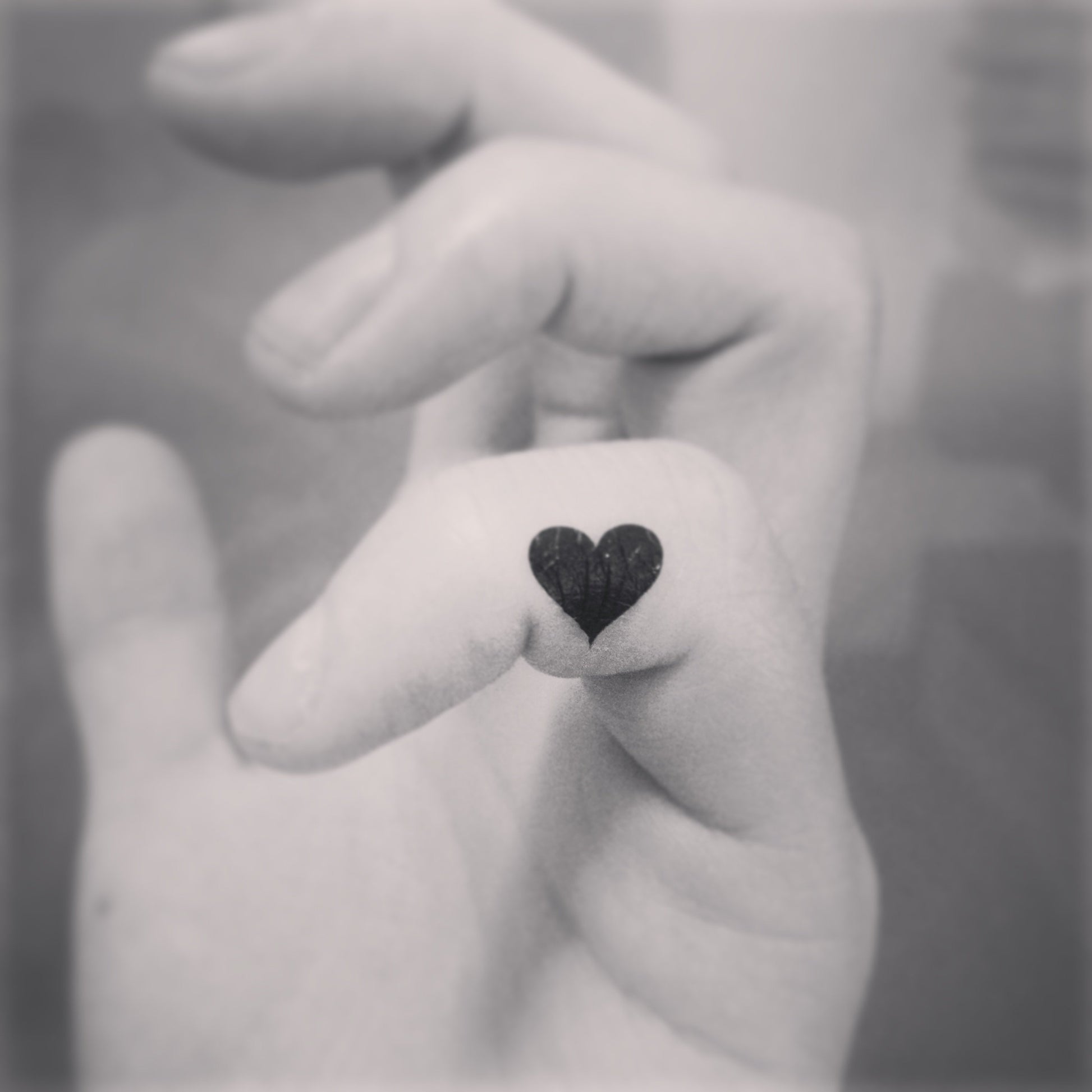 fake tiny mini black heart minimalist temporary tattoo sticker design idea on finger