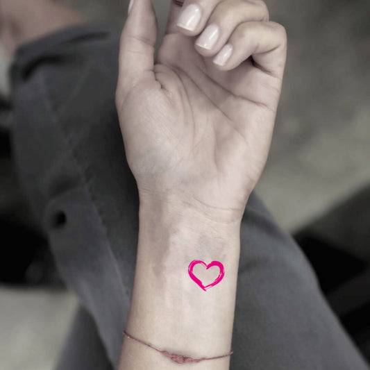 fake tiny pink heart color minimalist temporary tattoo sticker design idea on wrist