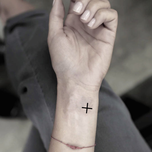 fake tiny plus sign minimalist temporary tattoo sticker design idea on wrist