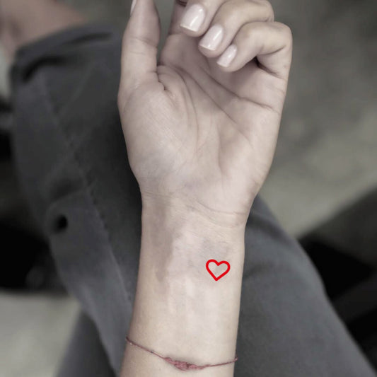 fake tiny red orange heart minimalist color temporary tattoo sticker design idea on wrist