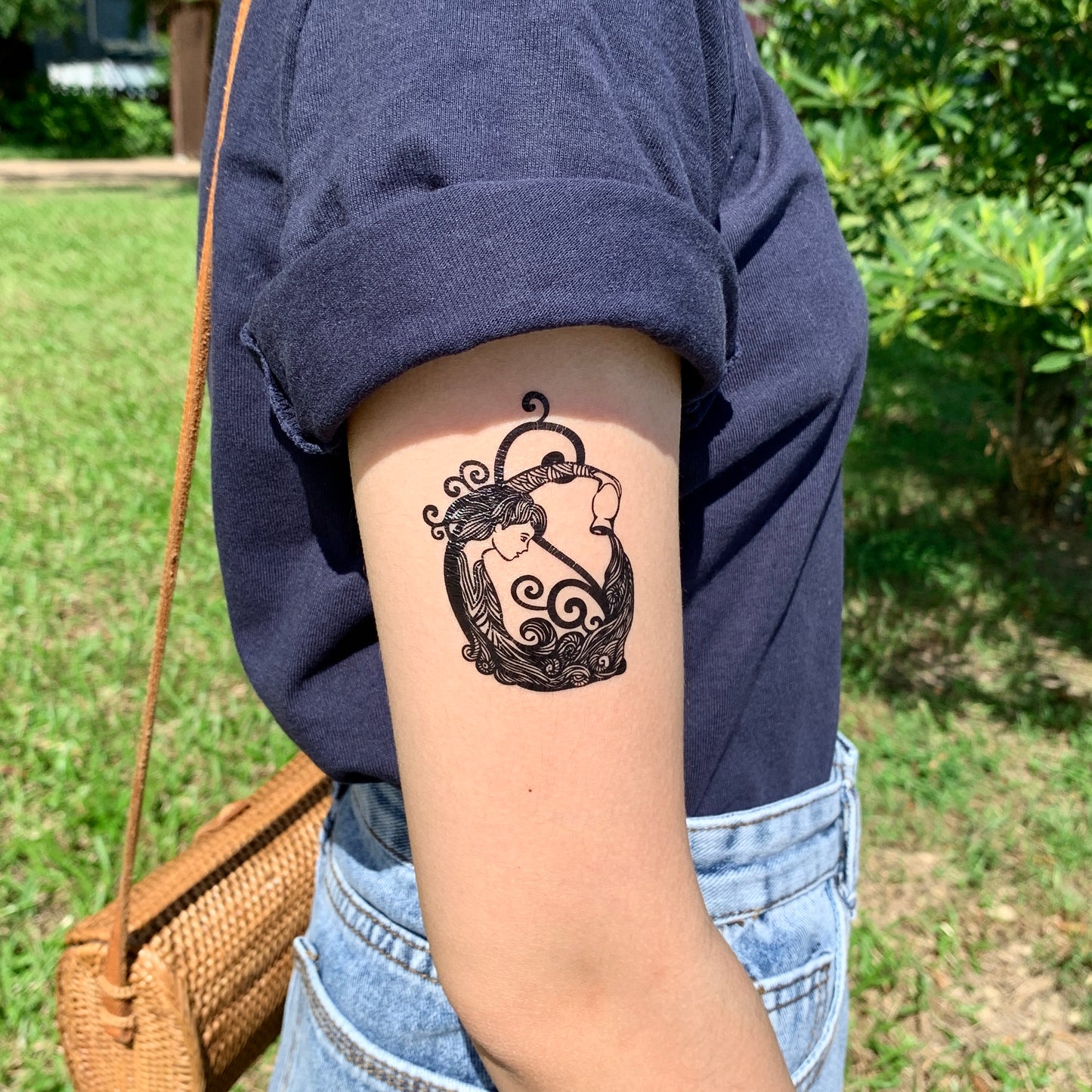 fake small water bearer aquarius zodiac horoscope woman lady god mermaid illustrative temporary tattoo sticker design idea on upper arm